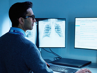 medical professional at a computer