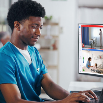 medical professional working at a computer