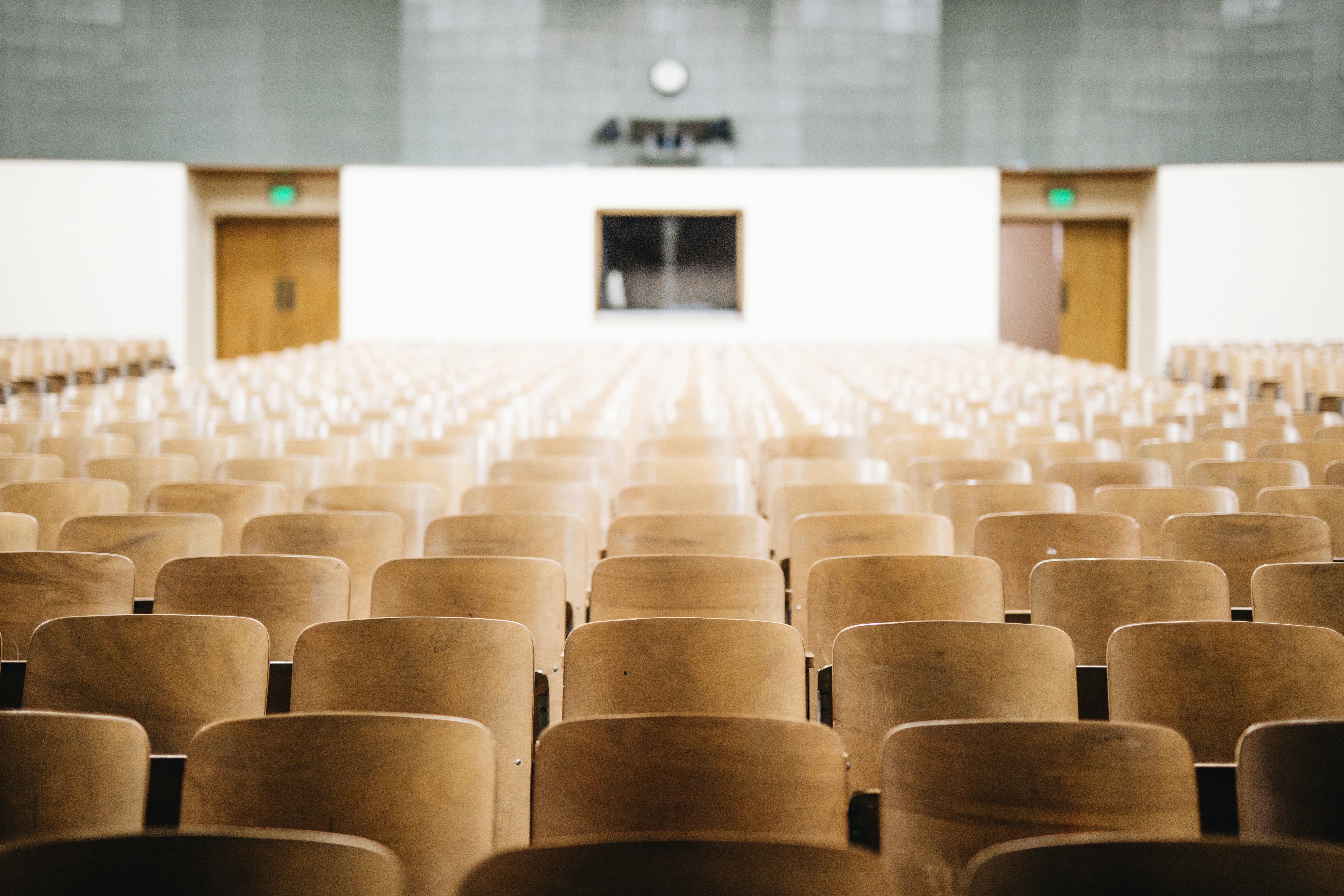 Rows of empty seats in a large conference auditorium.